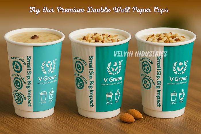 VELVIN INDUSTRIES – V GREEN Plus premium double wall paper cup with hot coffee splash, displayed in a modern café setting